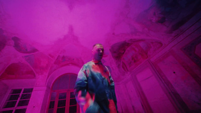 a man standing in front of a pink light