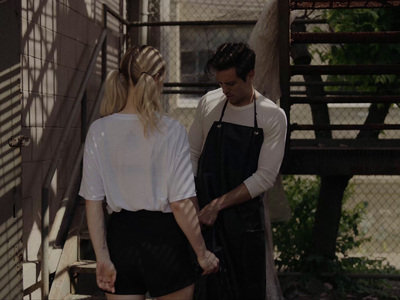 a man standing next to a woman on the steps