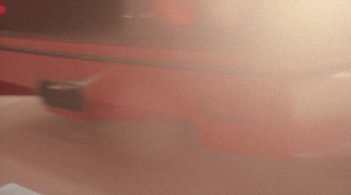 a blurry picture of a red suitcase on a table