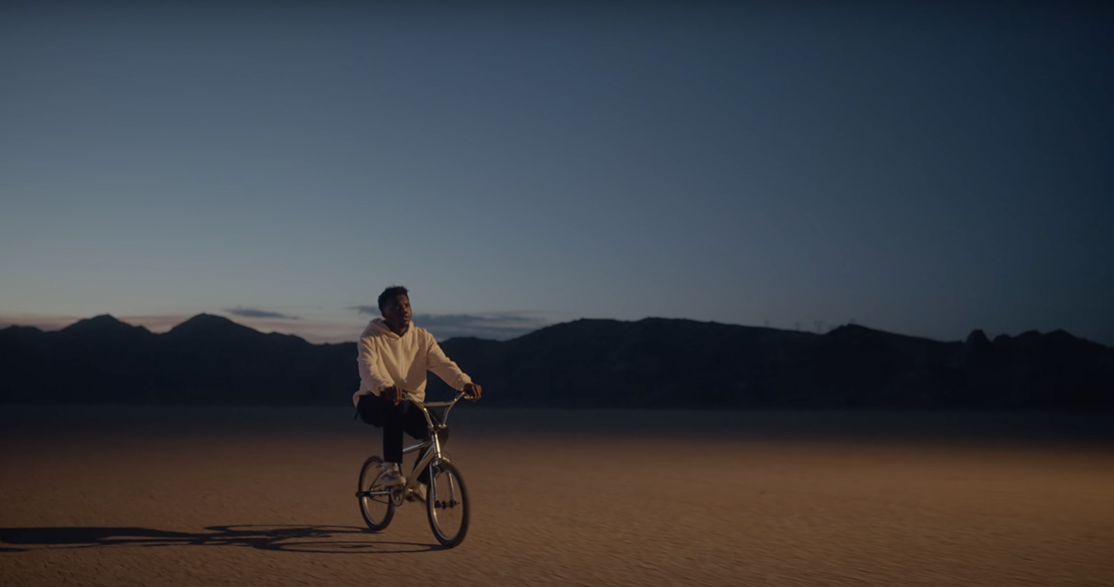 a man riding a bike in the middle of a desert