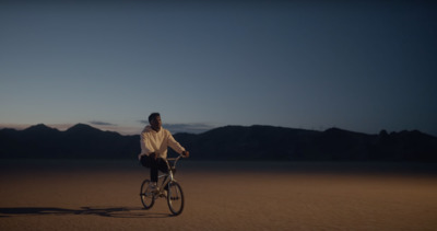 a man riding a bike in the middle of a desert