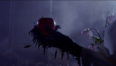 a person holding a flower and an apple