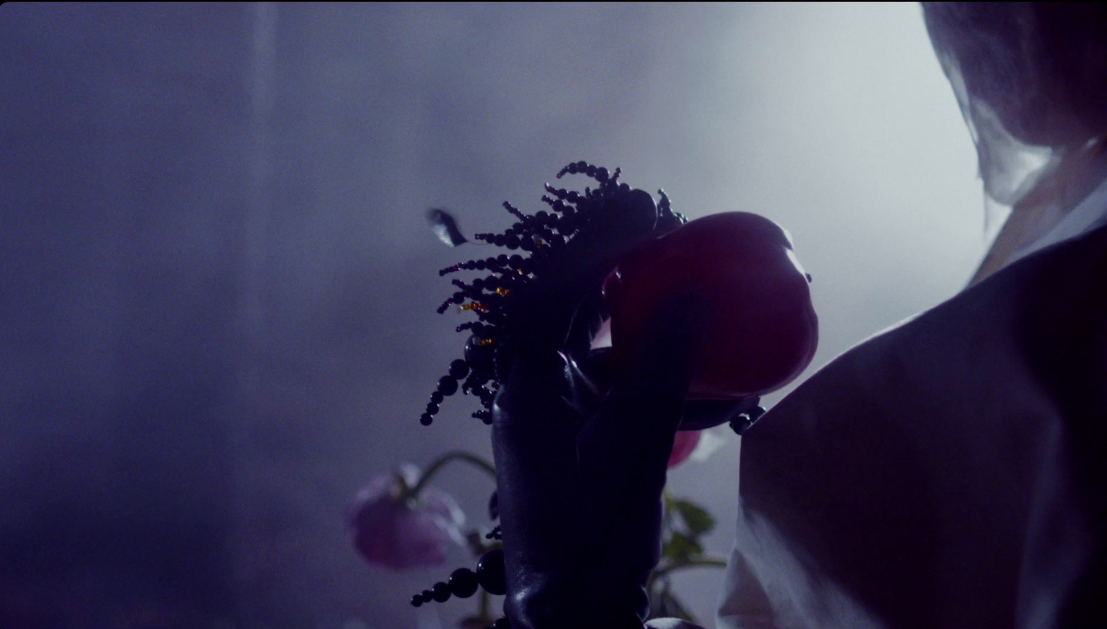 a woman holding a bunch of flowers in her hand