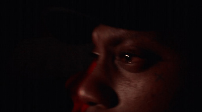 a close up of a person's face in the dark