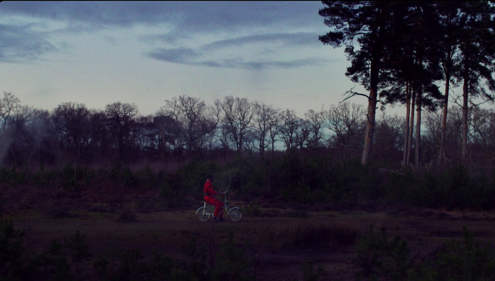 a person riding a bike in a field