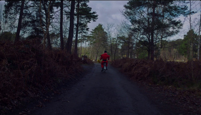 a person riding a bike down a dirt road