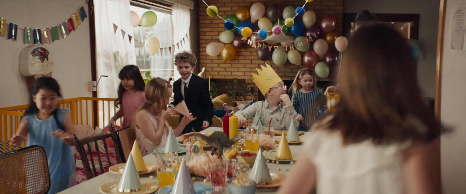 a group of children standing around a table