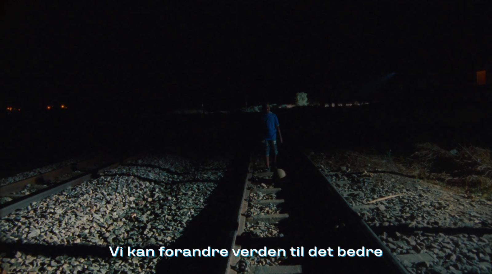 a person standing on a train track at night