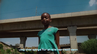 a young girl standing in front of a bridge