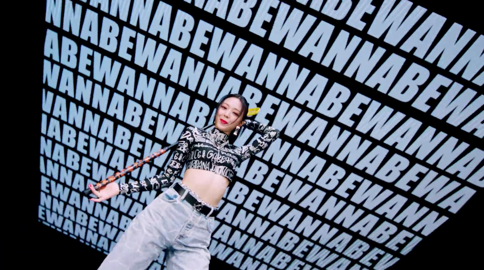 a woman standing in front of a wall with words on it