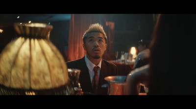 a man in a suit and tie sitting at a table