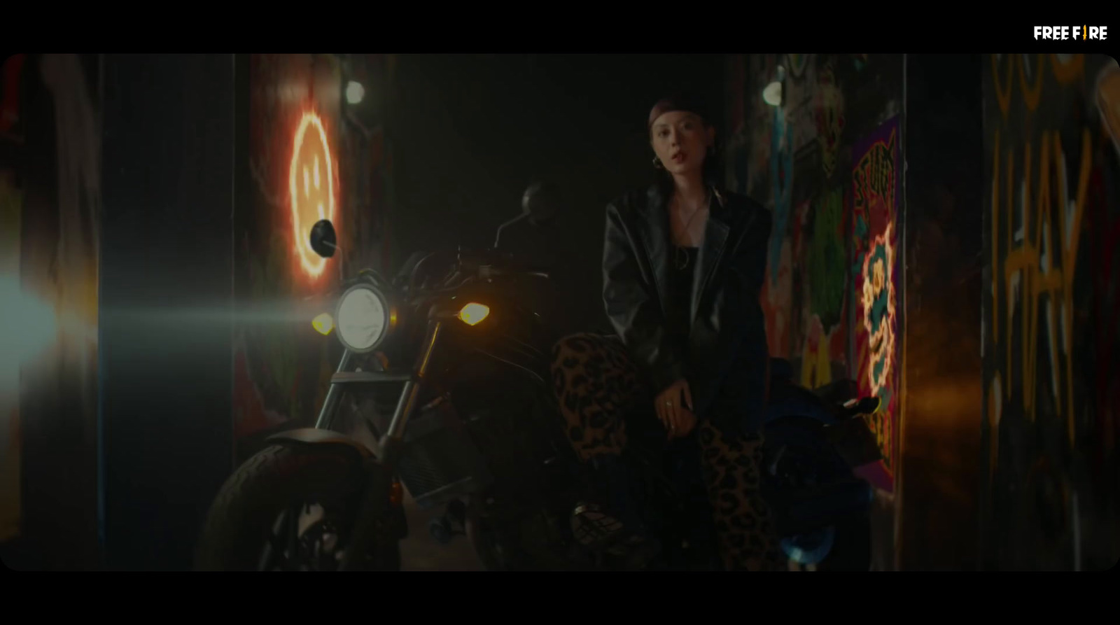 a woman standing next to a motorcycle in a dark room