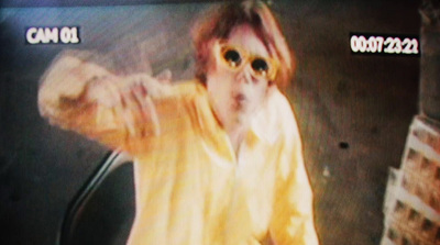 a person wearing sunglasses and a yellow shirt