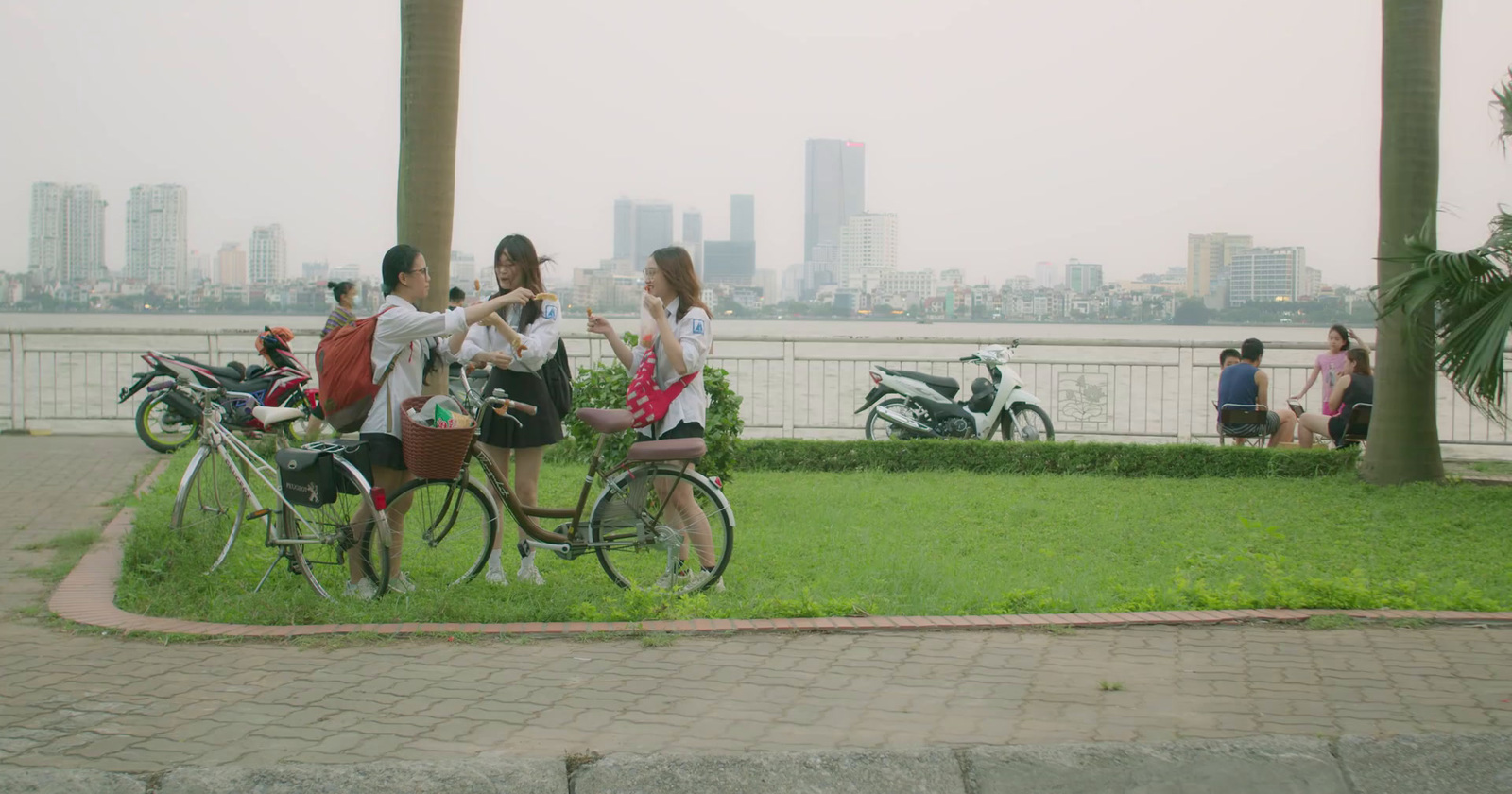 a group of people riding bikes next to each other