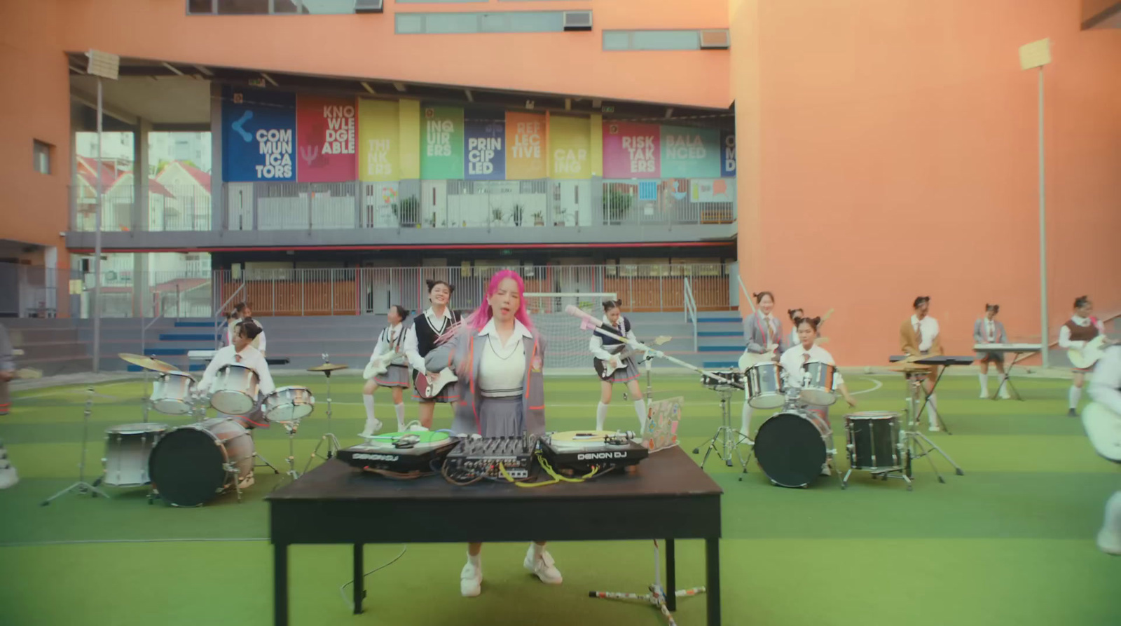 a group of people standing on top of a green field