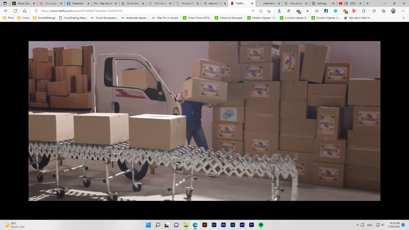 a man standing next to boxes on a conveyor belt