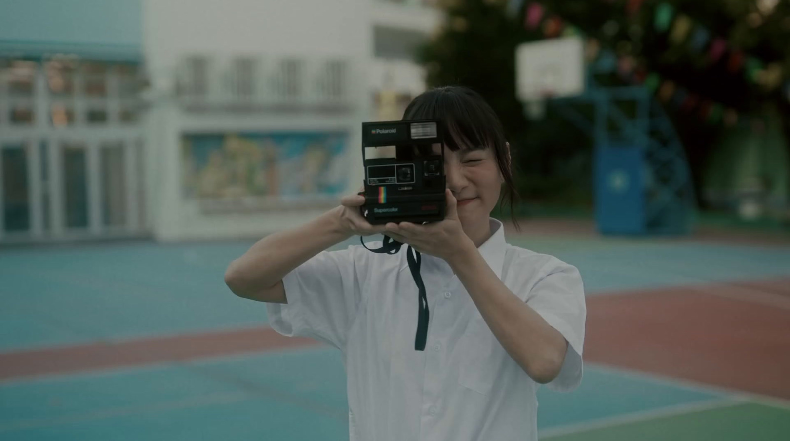 a woman taking a picture of herself with a camera