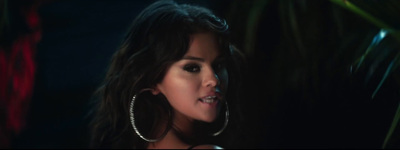 a close up of a person wearing large hoop earrings