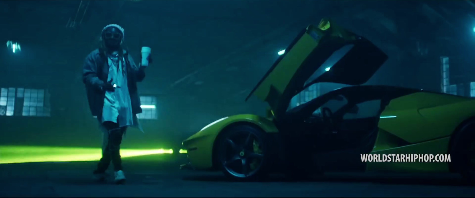 a man standing next to a yellow sports car