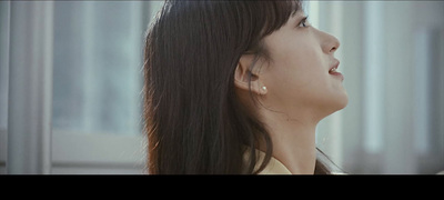 a woman with long black hair looking up