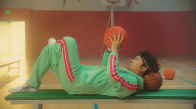 a man laying on a basketball court holding a basketball