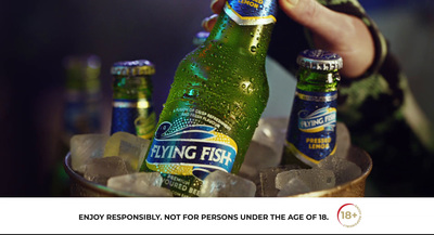 a person holding a beer bottle in a bucket of ice