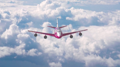 an airplane flying above the clouds in the sky