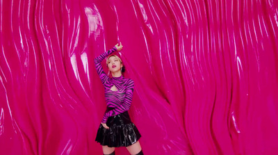 a woman in a black skirt and a pink background