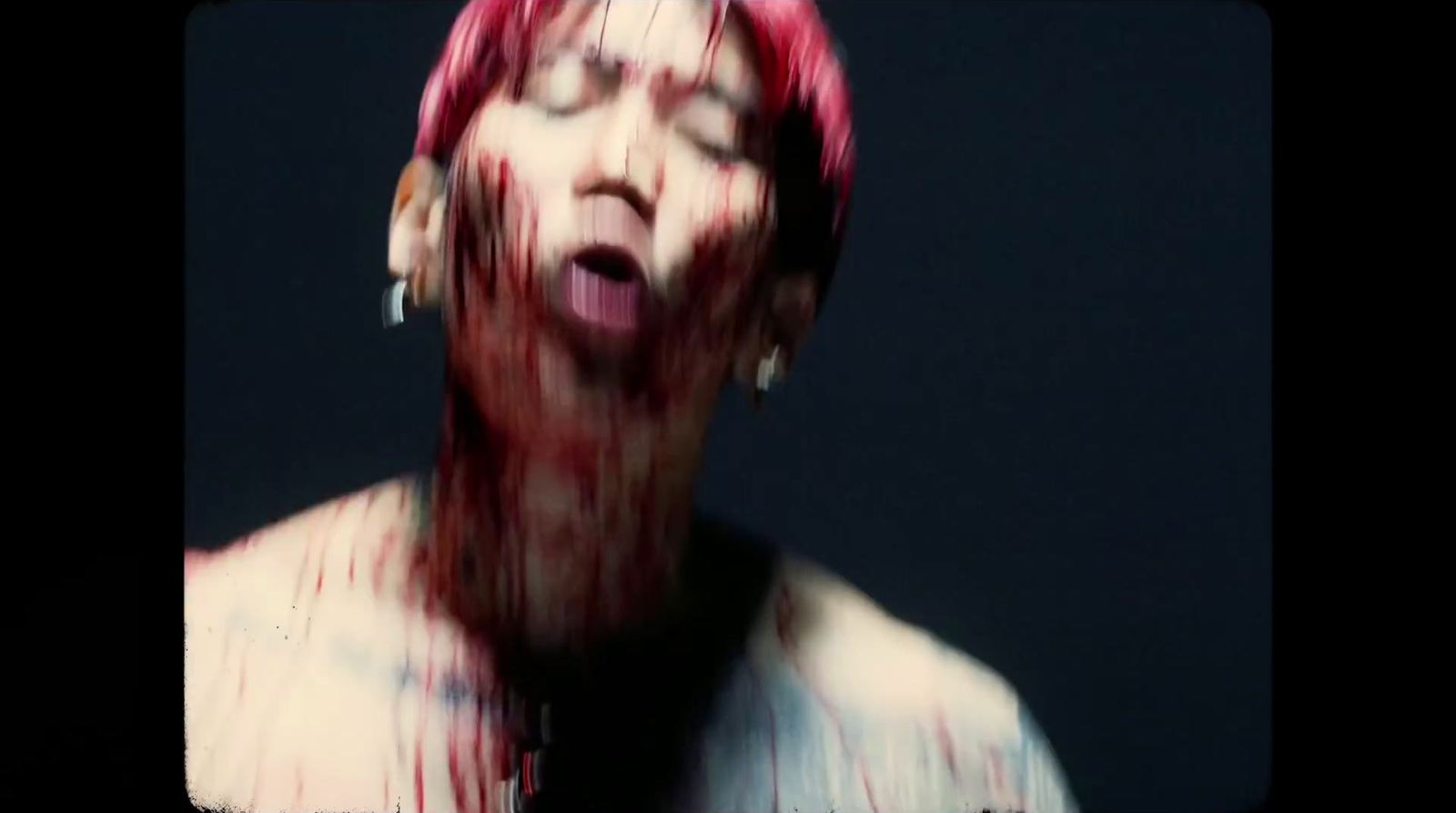 a woman with pink hair and piercings is covered in blood