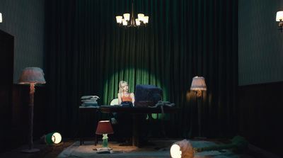 a woman sitting at a table in a dimly lit room