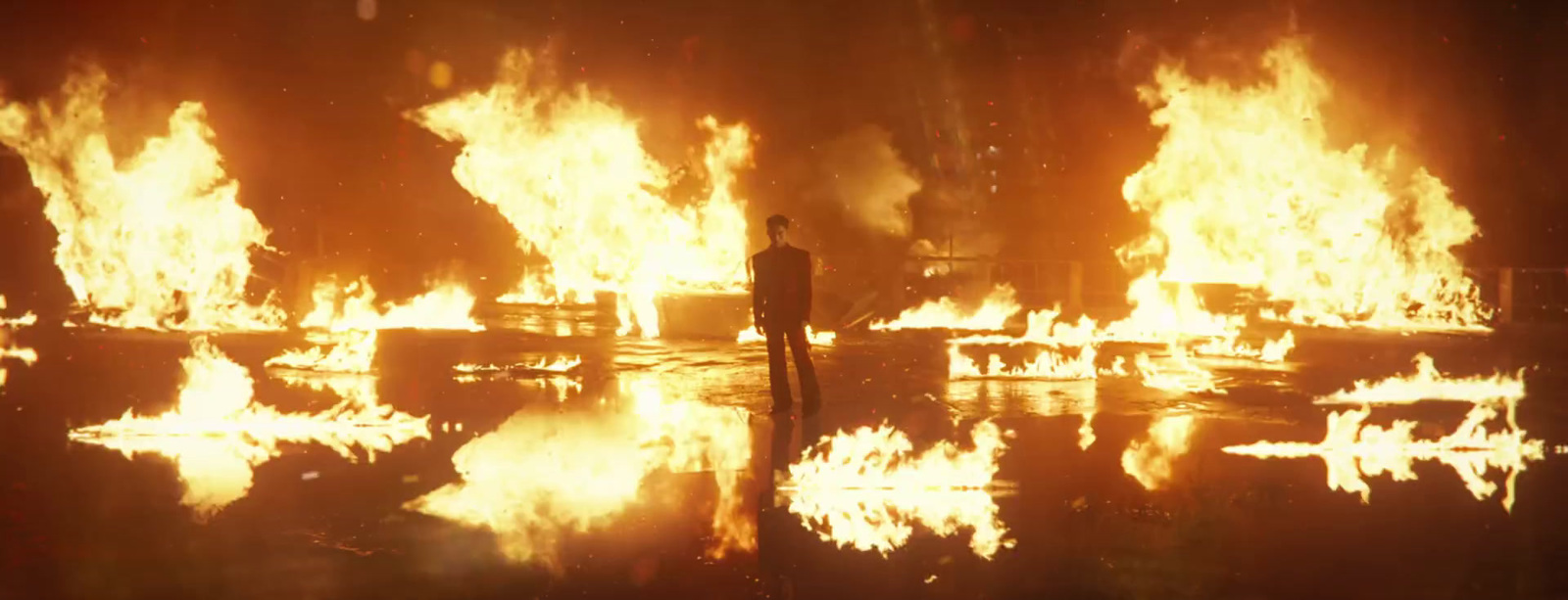 a person standing in front of a large fire