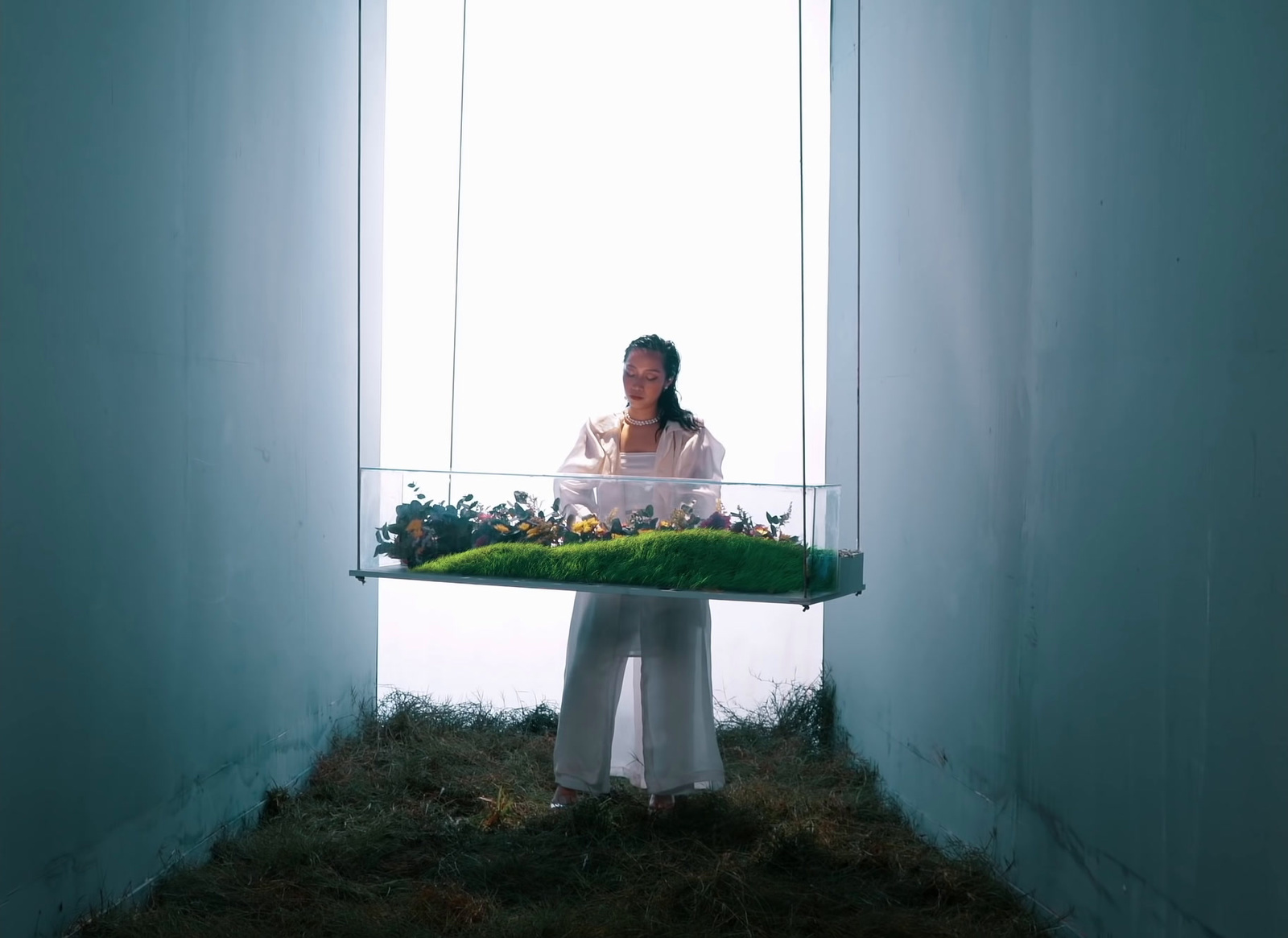 a woman standing behind a display of flowers