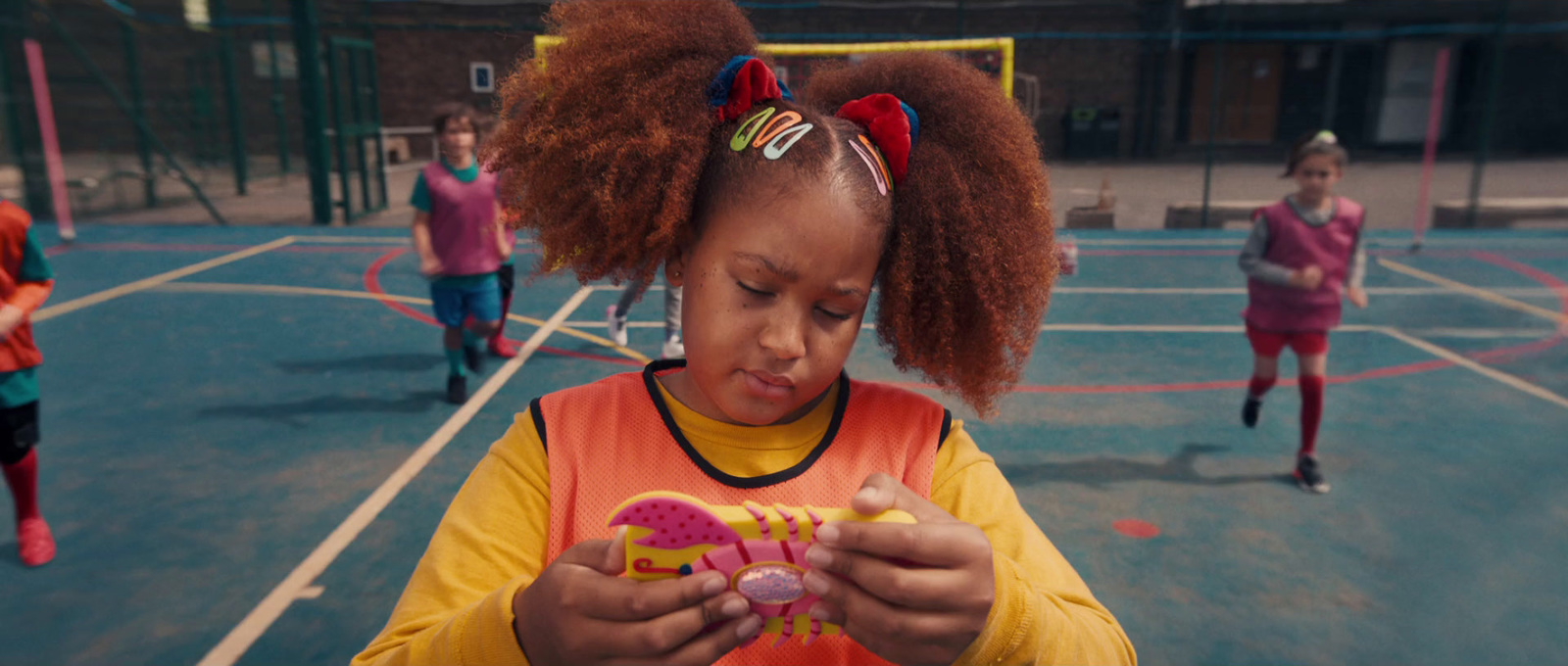 a little girl holding a toy in her hands