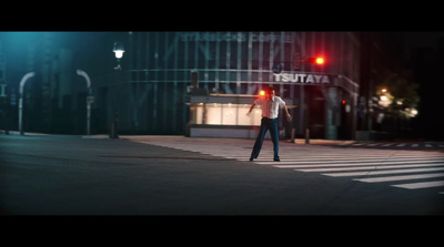 a man standing in the middle of a street at night