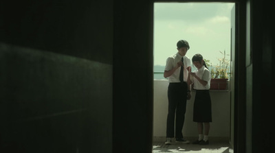 a man and a woman standing on a balcony