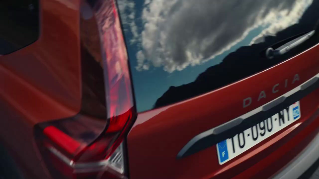 the back of a red car with a sky background