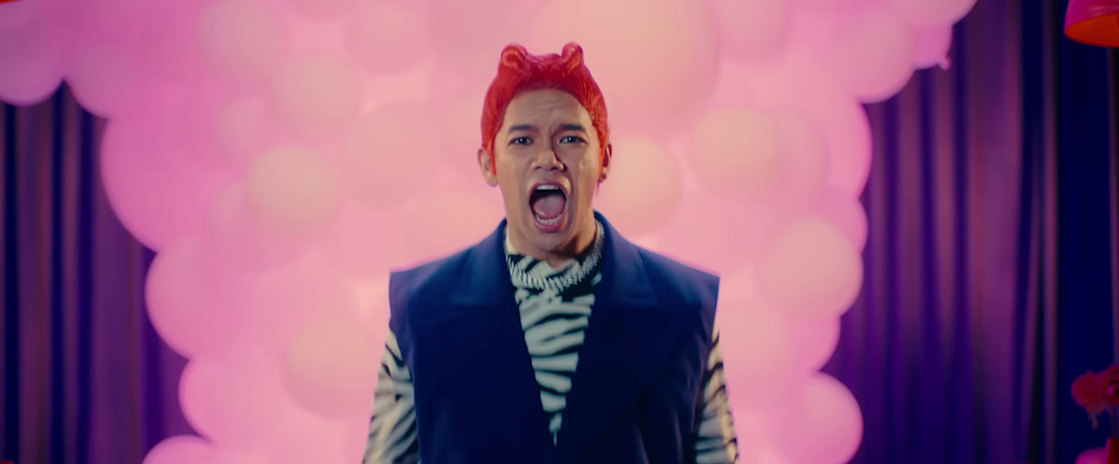 a man with red hair is making a funny face