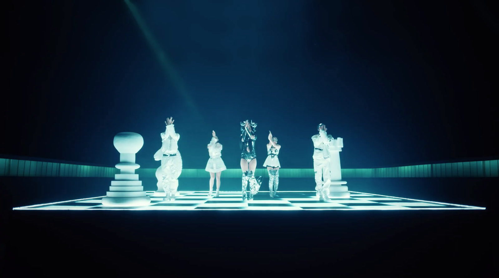 a group of people standing on top of a chess board