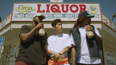 a group of men standing in front of a liquor store