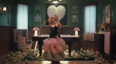 a woman standing in a room with lots of cups on the floor