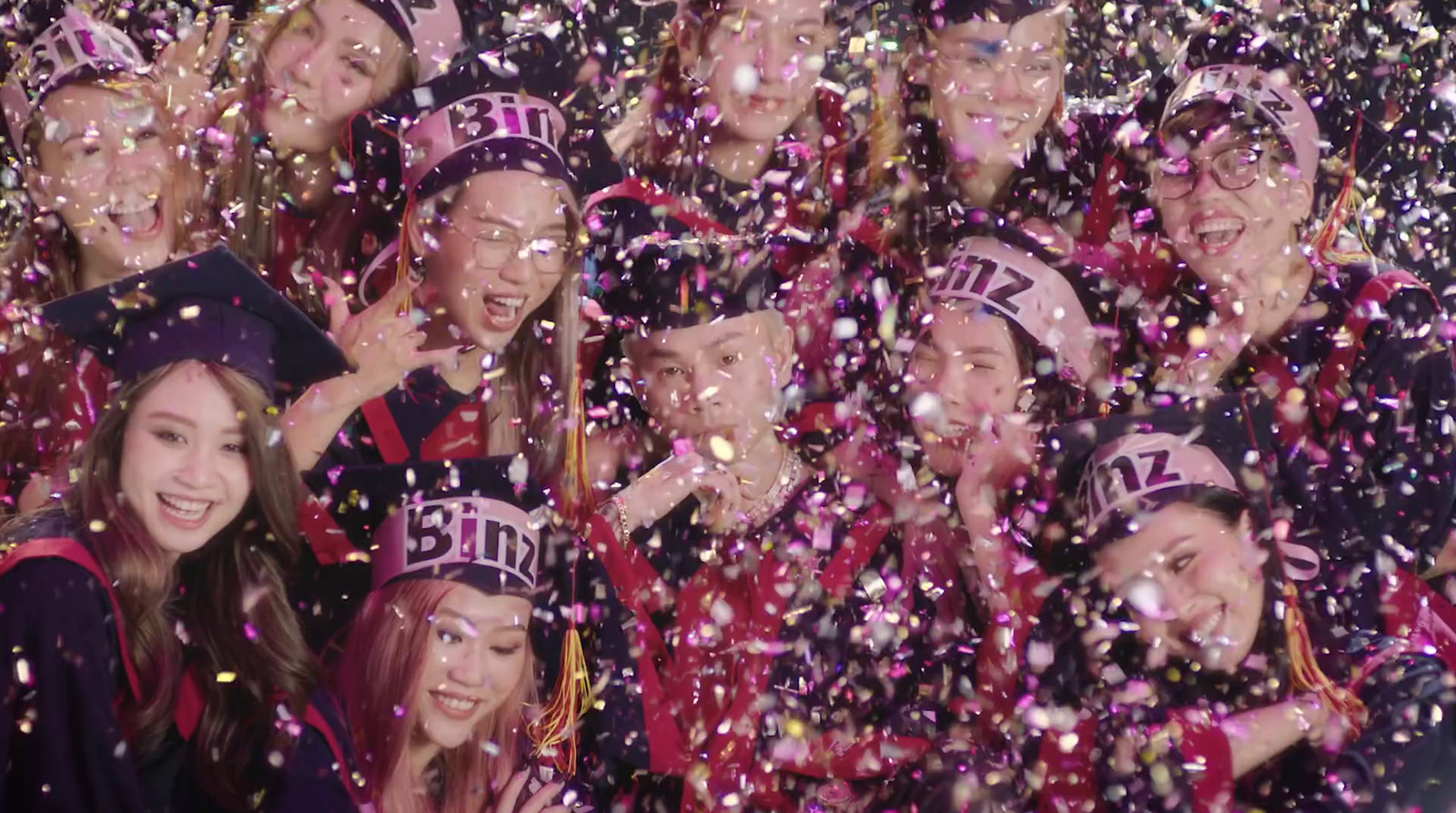 a group of people standing next to each other under confetti