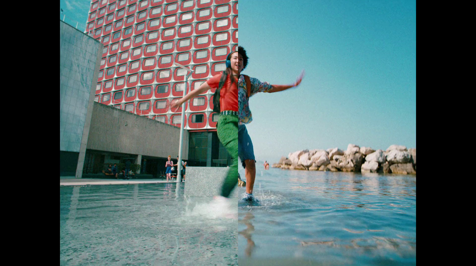 a man is standing in the water in front of a building