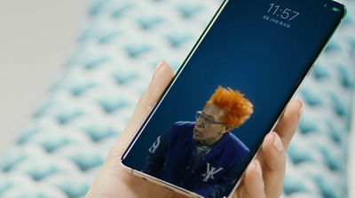 a person holding a cell phone with a picture of a man with orange hair