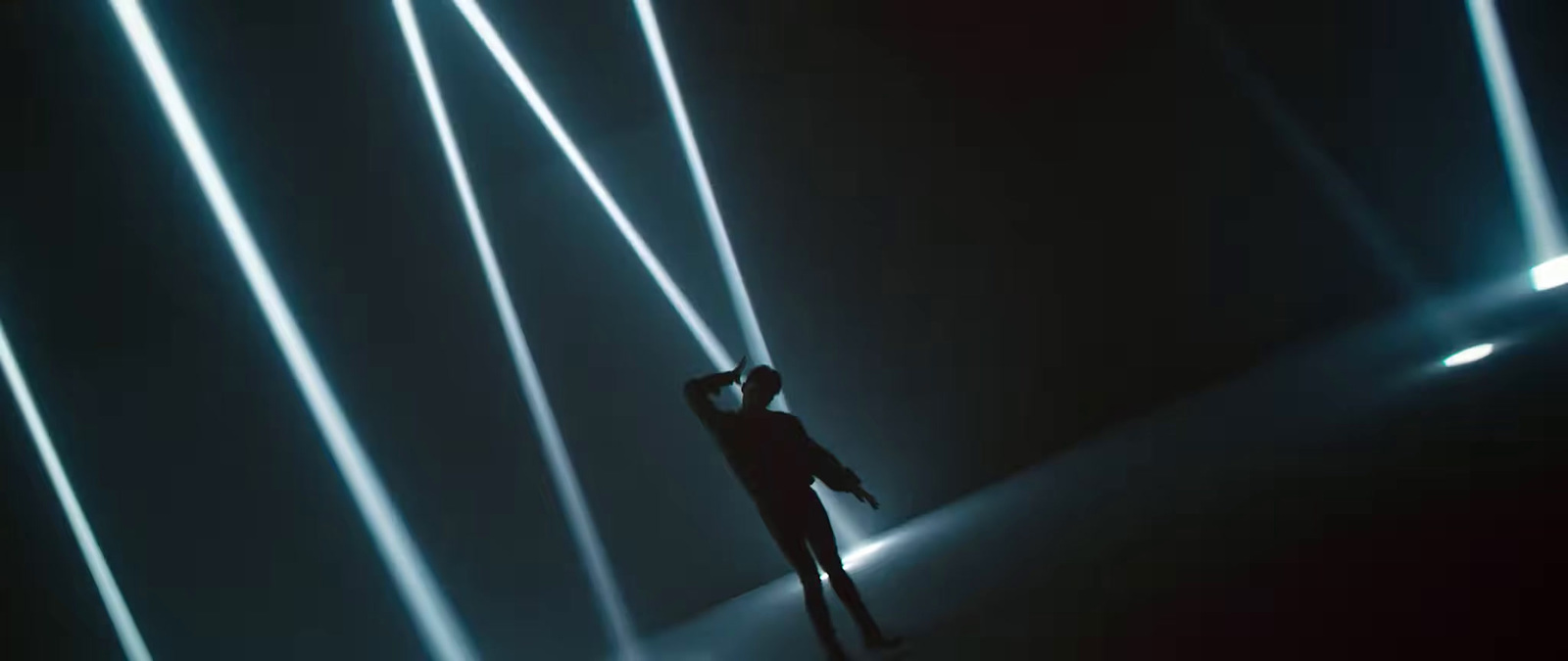 a person standing in a dark room with lights