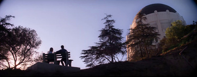 a couple of people sitting on top of a bench