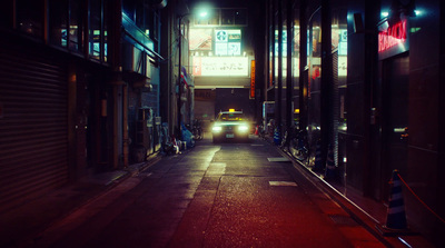 a car driving down a street at night