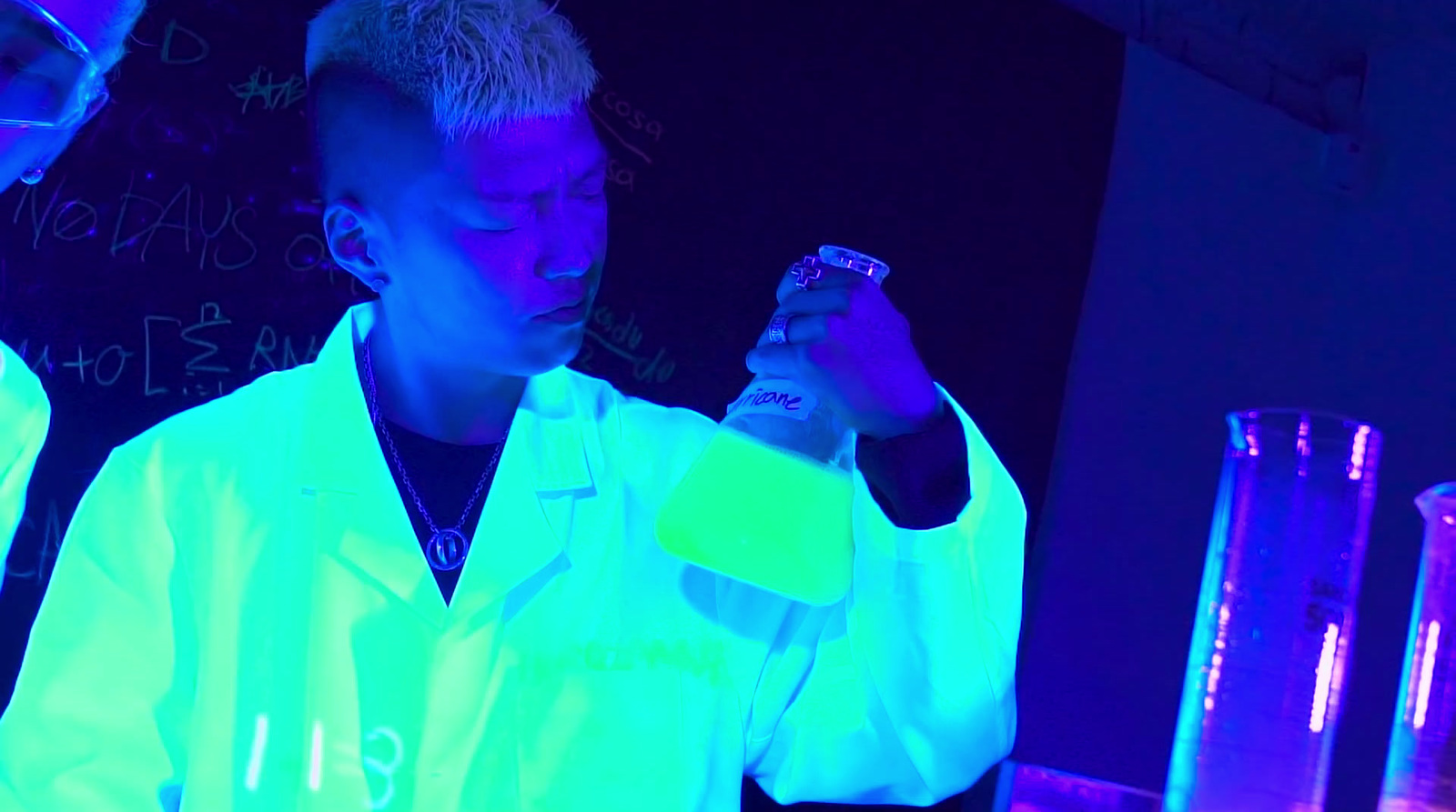 a couple of people in lab coats working in a lab