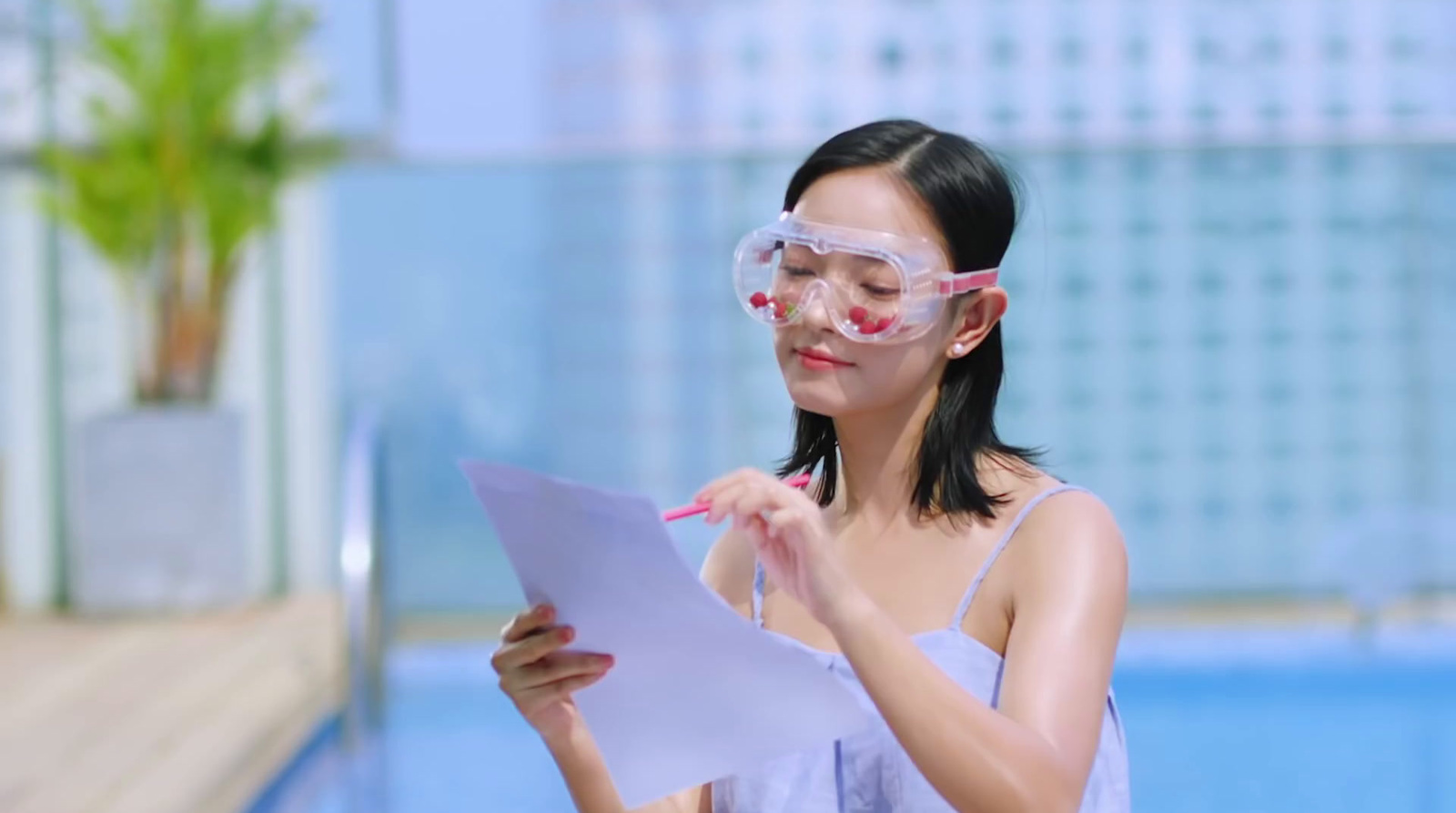 a woman wearing goggles and holding a piece of paper