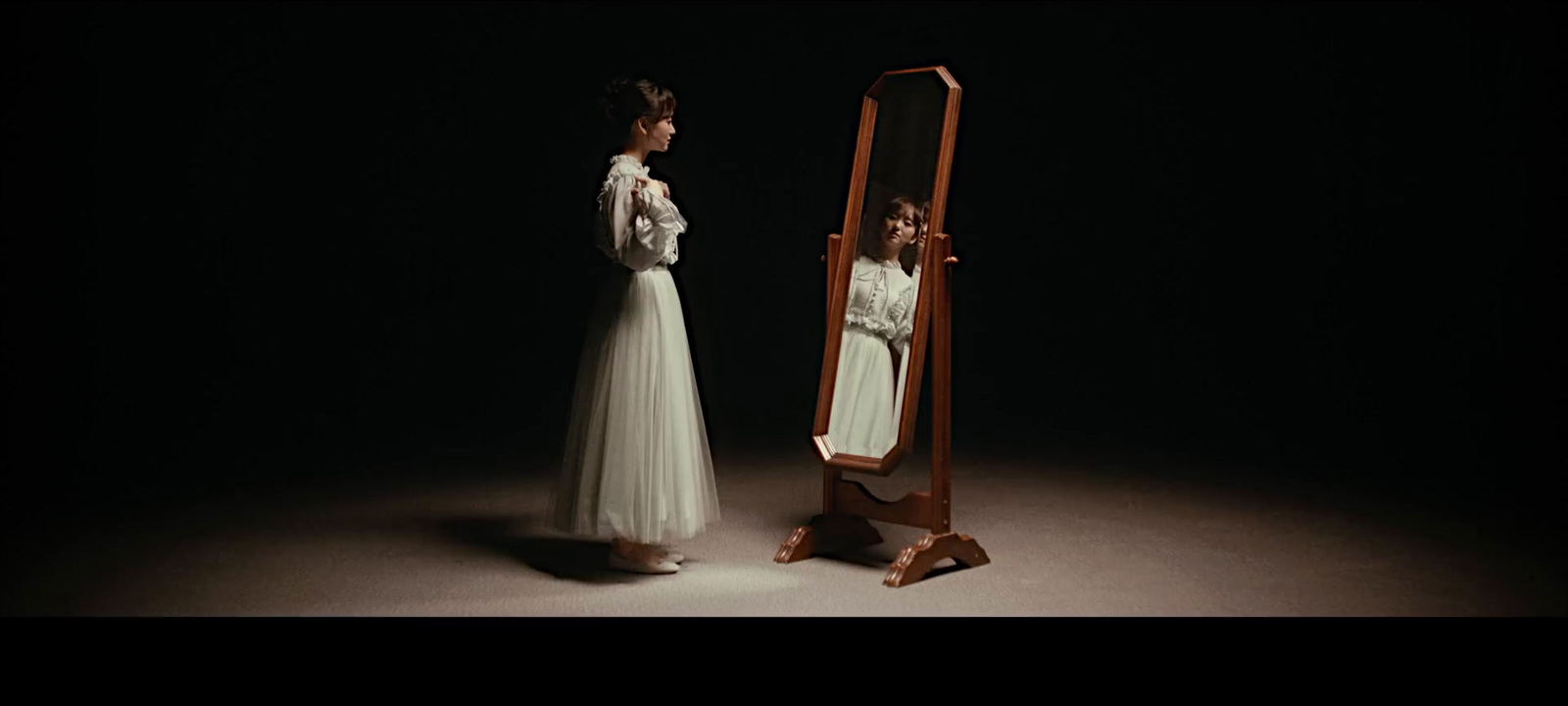 a woman standing in front of a mirror