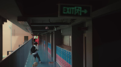 a person walking down a hallway with a bag